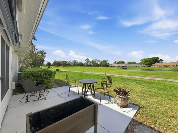 a view of a swimming pool and outdoor seating