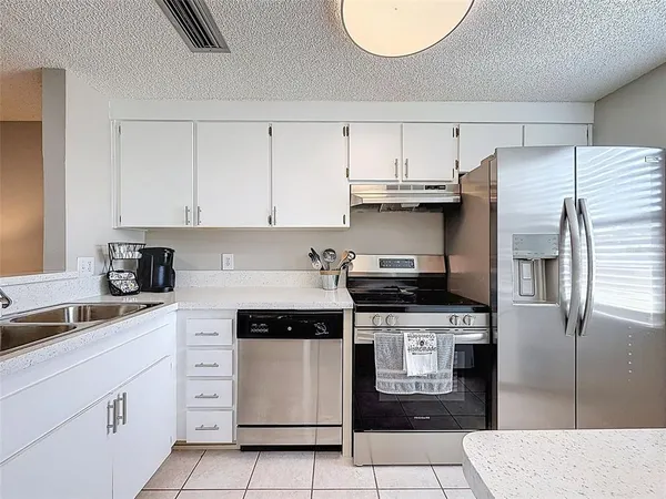 a kitchen with cabinets appliances and a sink