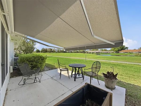 a view of a chairs and table in patio