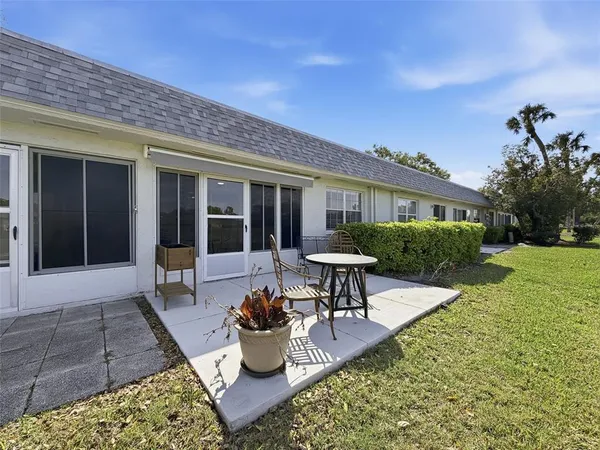 a view of a house with backyard sitting area and garden
