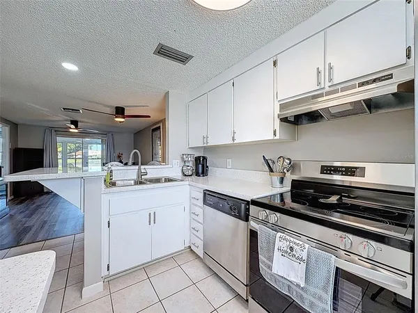 a kitchen with stainless steel appliances granite countertop a sink and cabinets