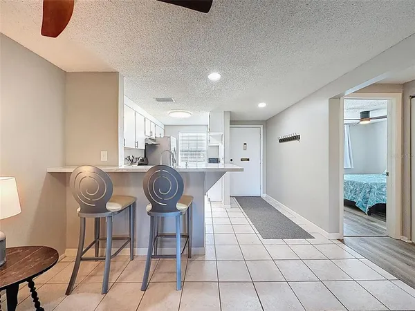 a living room with furniture a rug and white walls