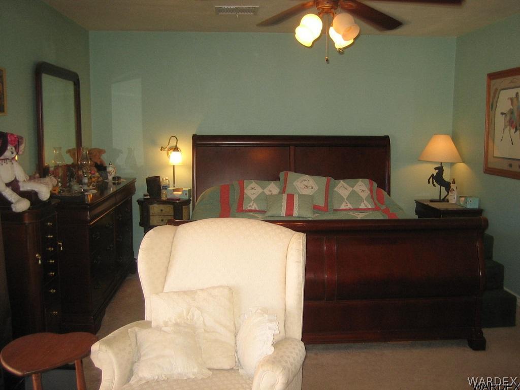 3064 Tennessee Road Golden Valley, AZ 86413 - Photo 8 of 32 a bedroom with a bed and a lamp on dresser