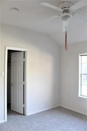 a view of room with a ceiling fan