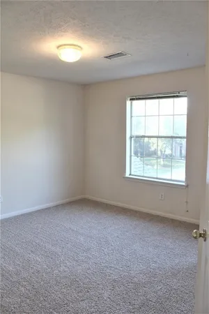 an empty room with a empty space and windows