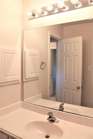 a bathroom with a tub sink and vanity