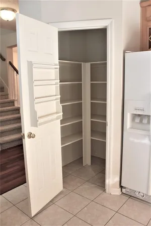 a view of walk in closet with empty racks