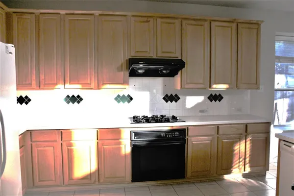 a kitchen with a cabinets and white appliances