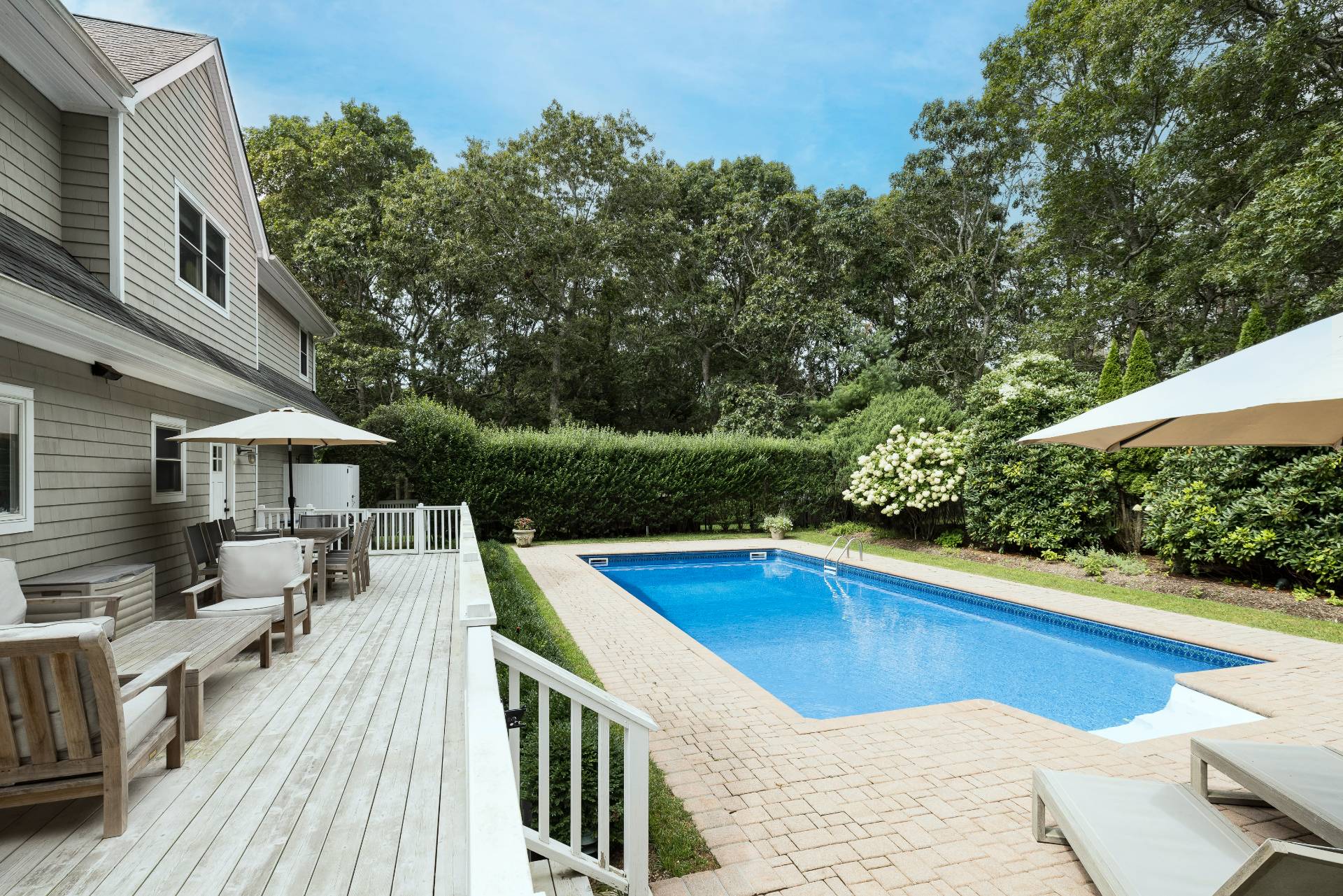 9 Central Avenue East Hampton, NY 11937 - Photo 3 of 21 a view of a house with pool fire pit couches and a patio