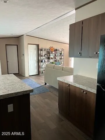 a kitchen with a sink a counter top space and cabinets