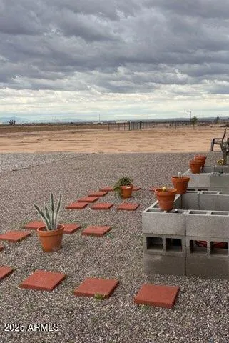 a view of a terrace with lawn chairs