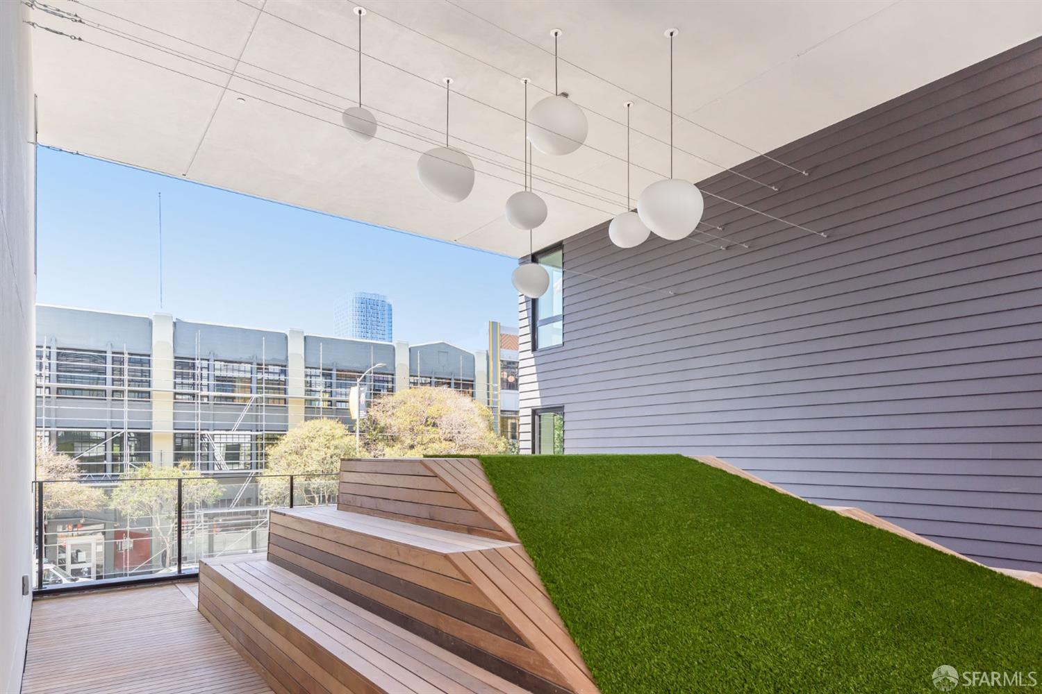 1288 Howard Street, Unit 509 San Francisco, CA 94103 - Photo 30 of 55 a view of a patio with a table chairs and wooden fence