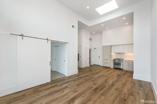 a view of a kitchen with a sink and a refrigerator