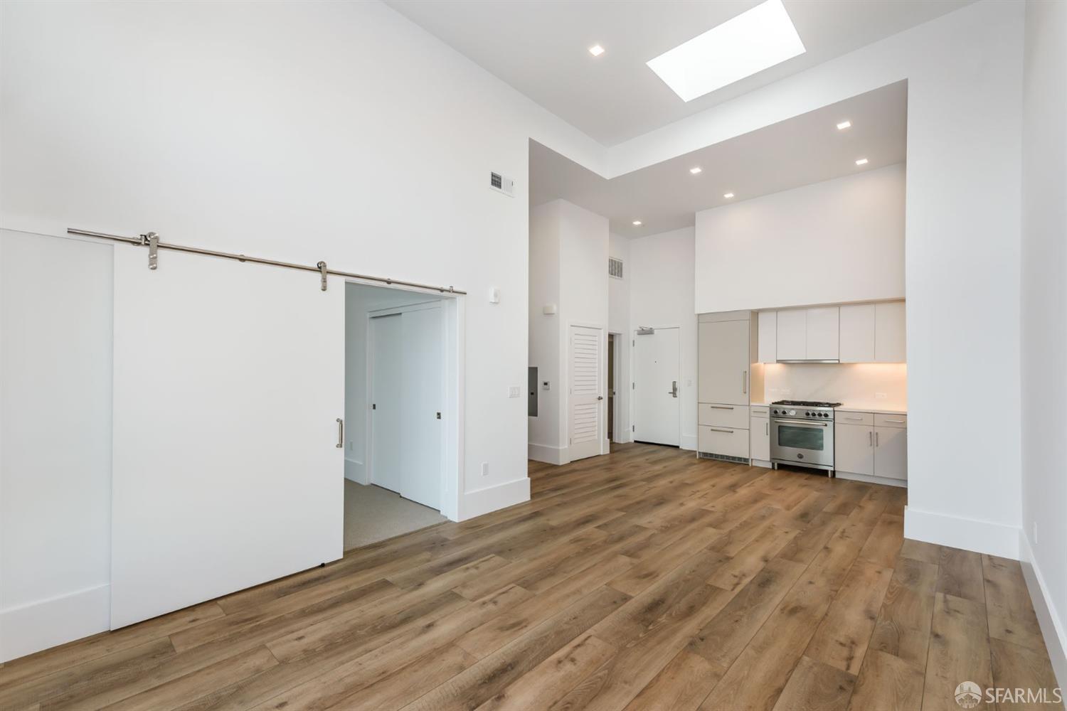 1288 Howard Street, Unit 509 San Francisco, CA 94103 - Photo 7 of 55 a view of a kitchen with a sink and a refrigerator
