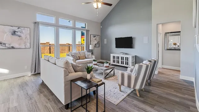 a living room with furniture a clock on wall and a table