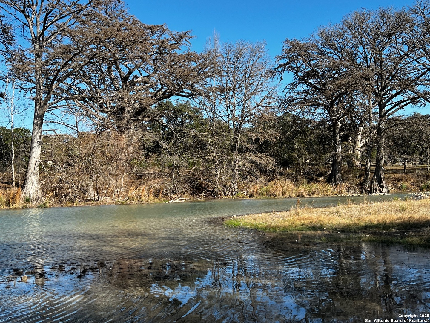 250 Redbud Road Concan, TX 78838 - Photo 8 of 10 a view of a lake with a yard
