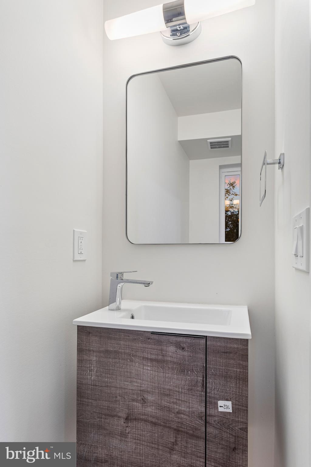 2220 13th Street Northeast Washington, DC 20018 - Photo 11 of 41 a bathroom with a sink and a mirror