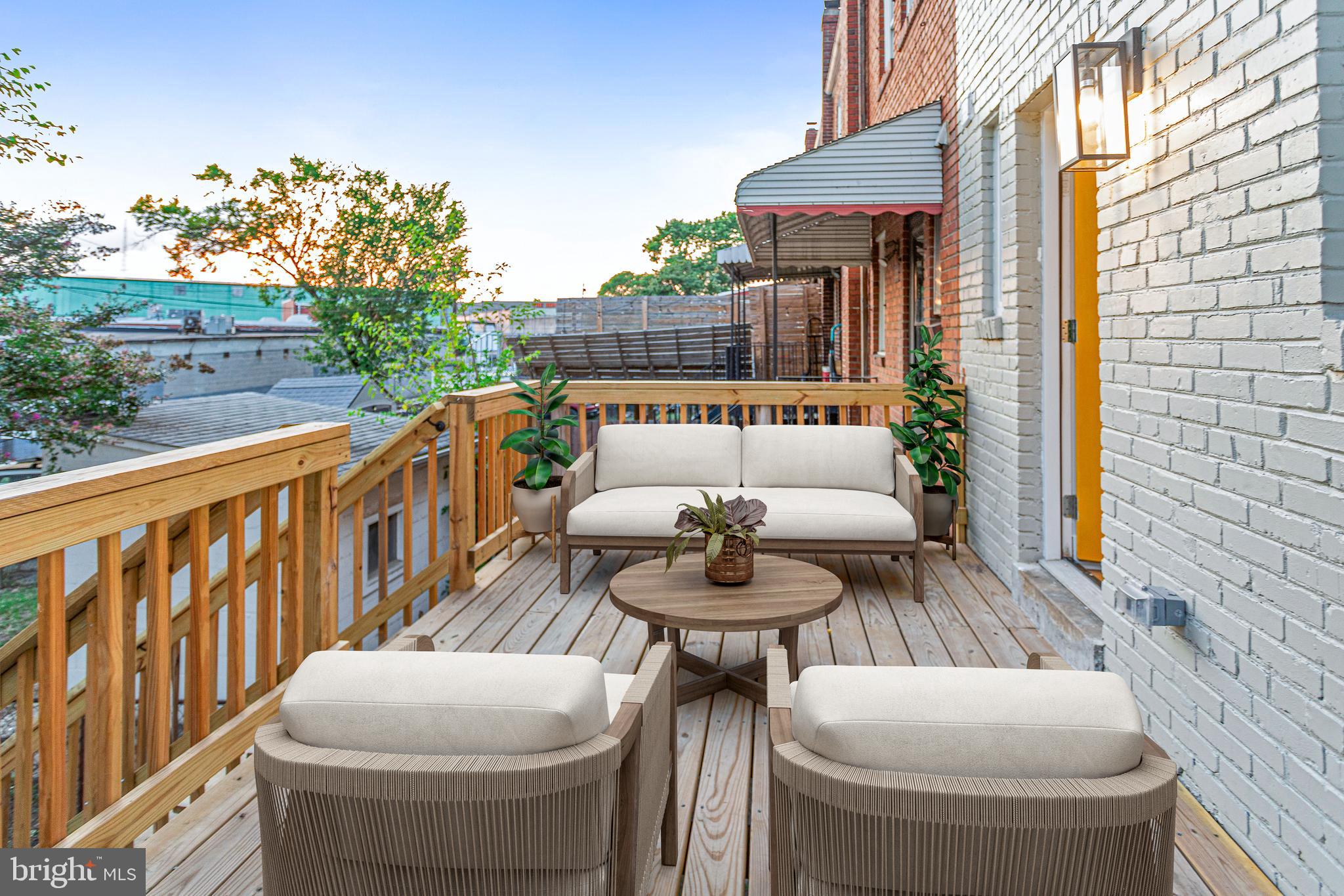 2220 13th Street Northeast Washington, DC 20018 - Photo 15 of 41 a view of a deck with couches table and chairs and potted plants