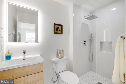 a view of a bedroom with wooden floor and cabinet