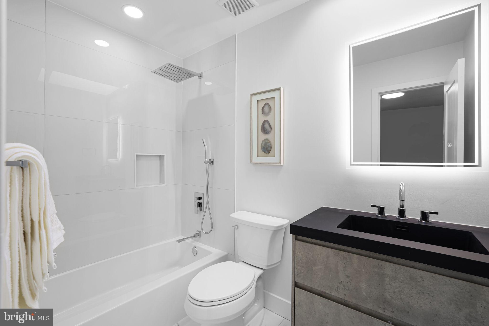 2220 13th Street Northeast Washington, DC 20018 - Photo 26 of 41 a bathroom with a sink a toilet and shower