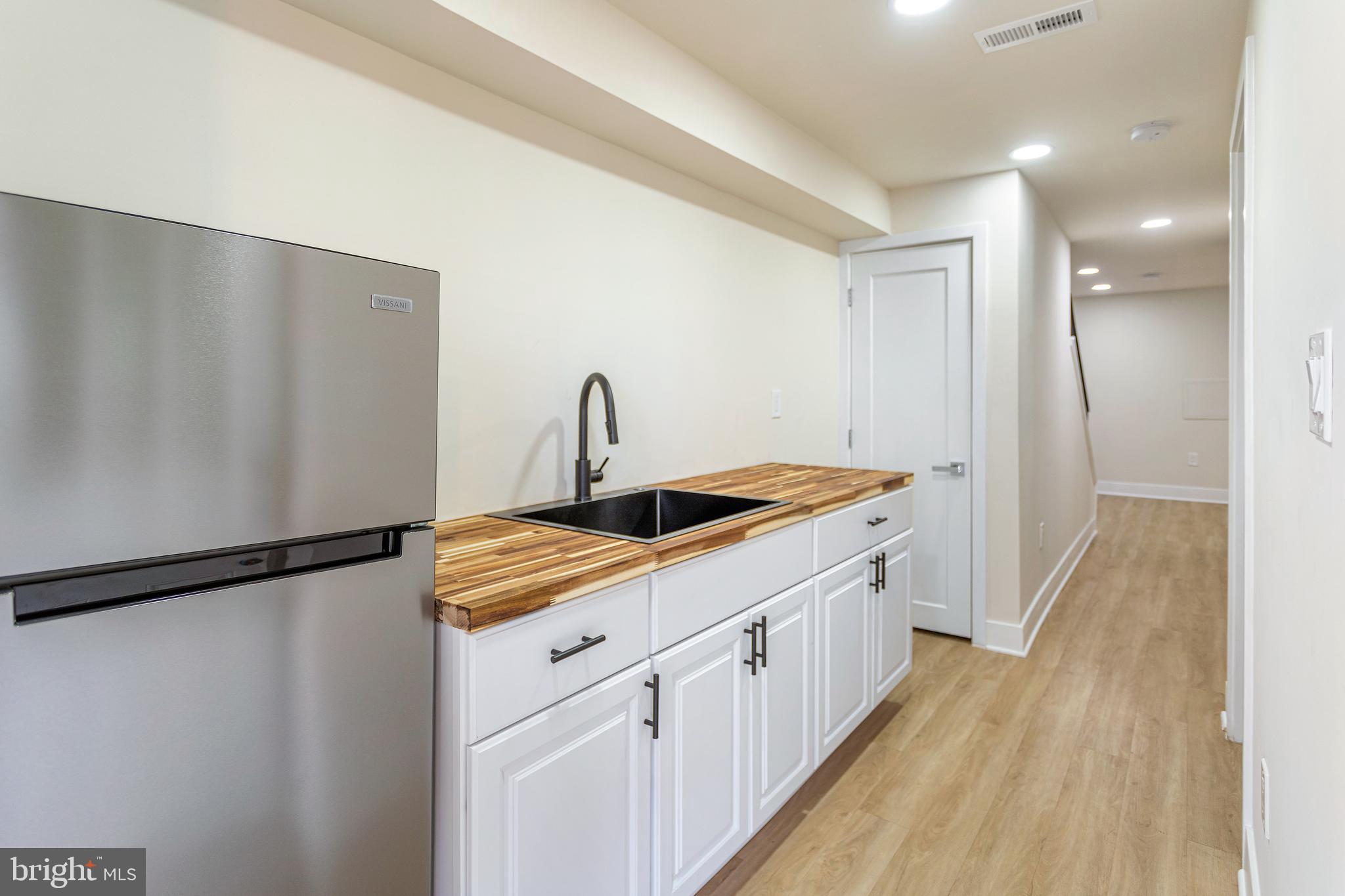 2220 13th Street Northeast Washington, DC 20018 - Photo 34 of 41 a kitchen with a sink and refrigerator