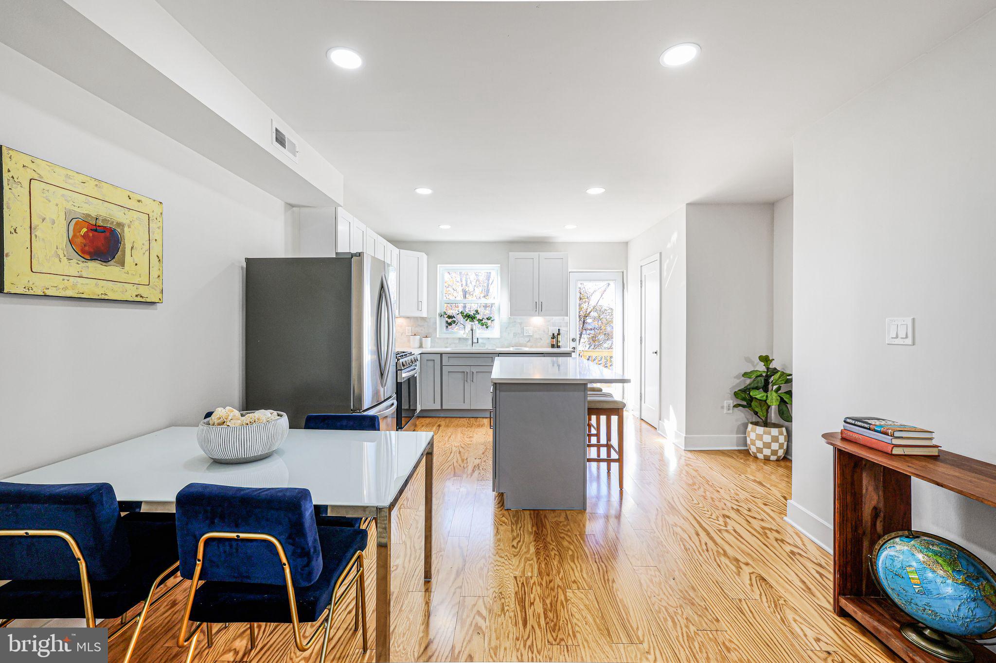 2220 13th Street Northeast Washington, DC 20018 - Photo 9 of 41 a living room with kitchen island furniture and a wooden floor