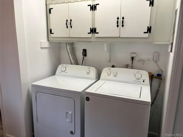 a view of cabinets and washer dryer
