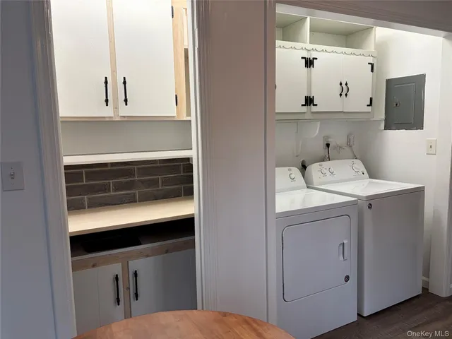 a view of room with hardwood floor and a window