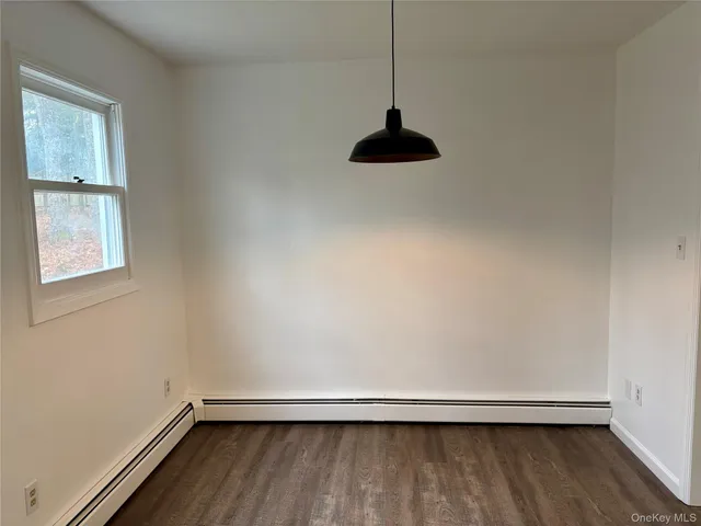 a living room with a flat screen tv and a window