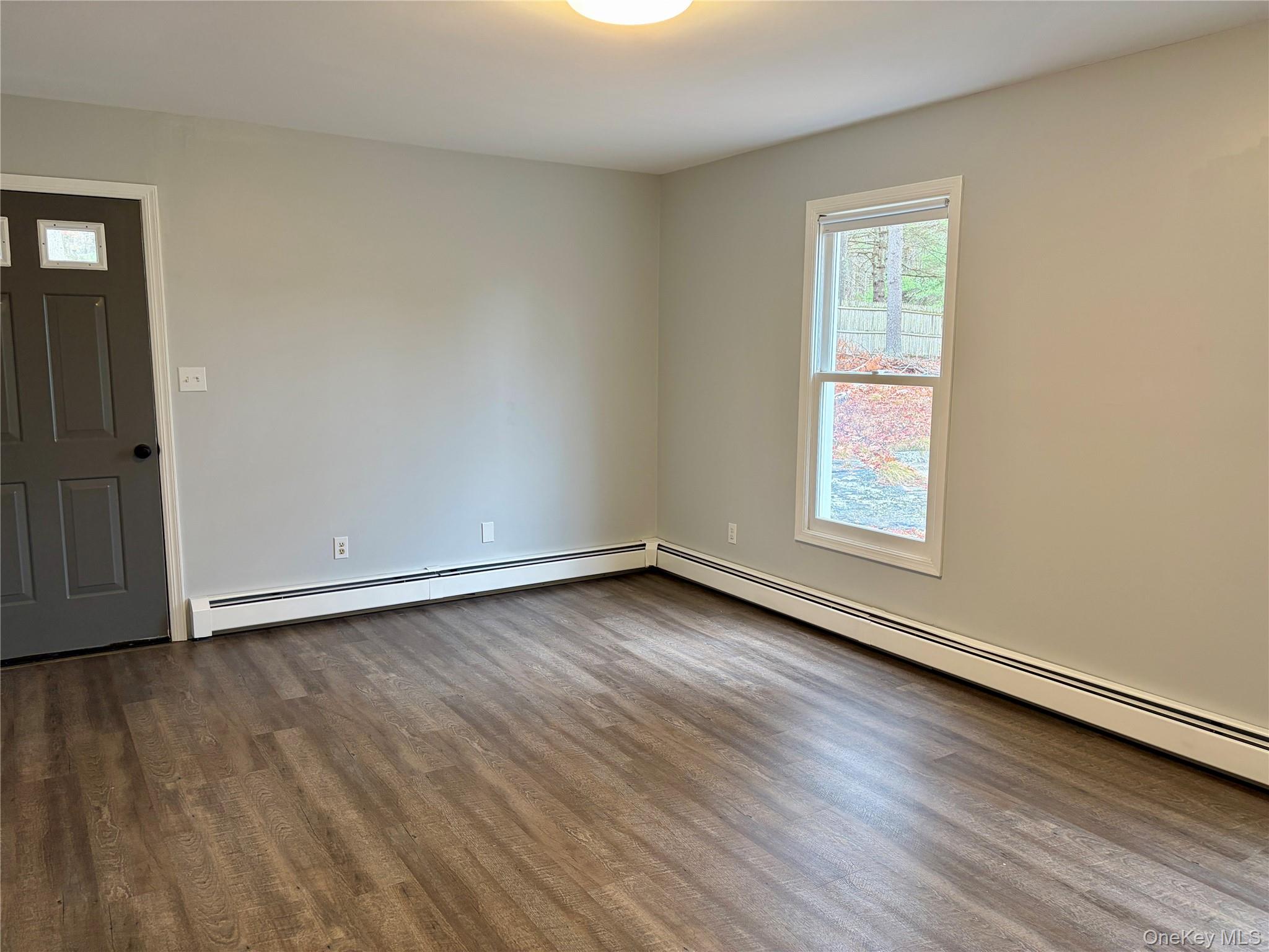 44 Gregory Road Glen Spey, NY 12737 - Photo 17 of 20 an empty room with wooden floor and windows