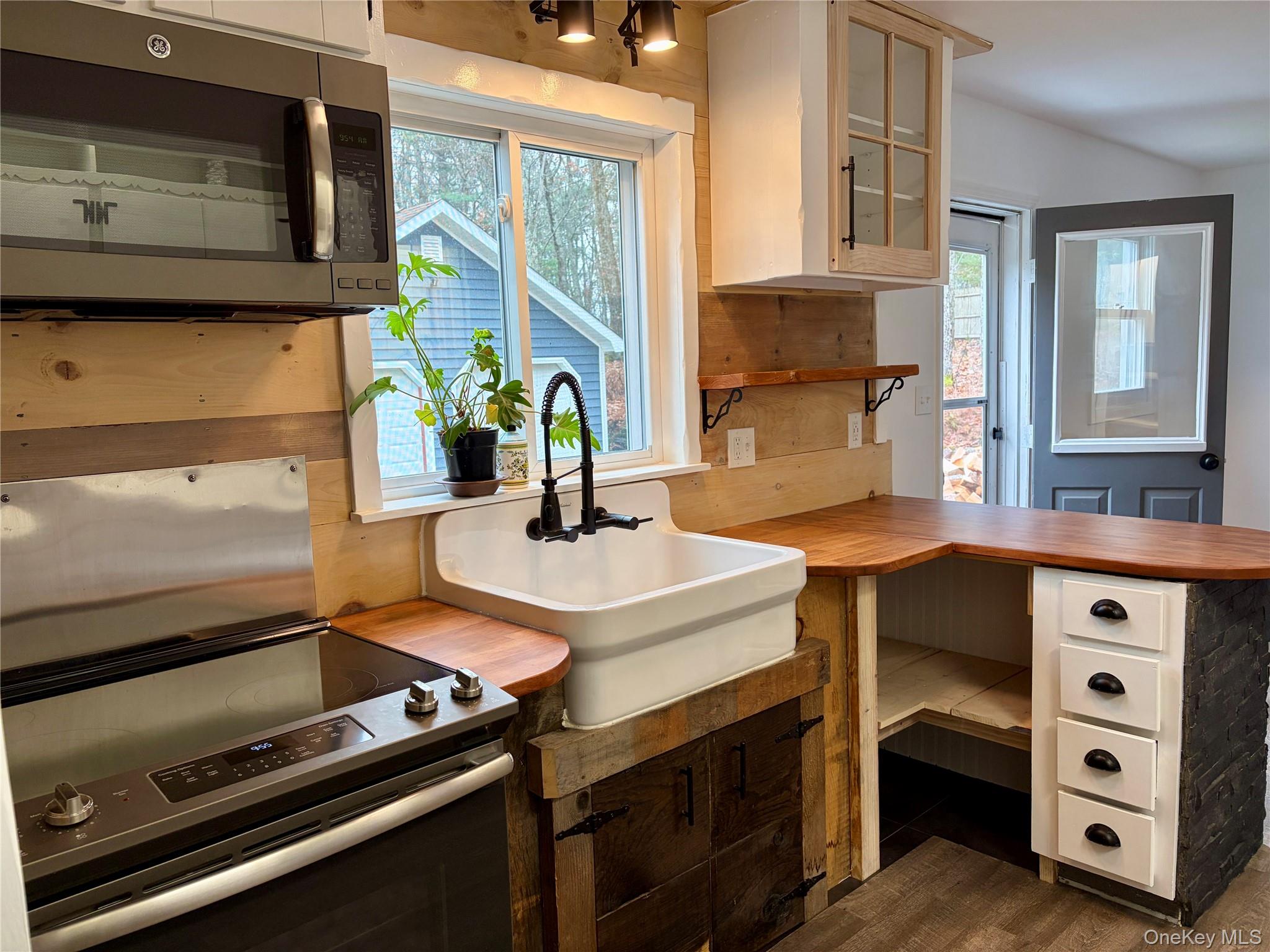 44 Gregory Road Glen Spey, NY 12737 - Photo 4 of 20 a kitchen with a stove a sink and a microwave
