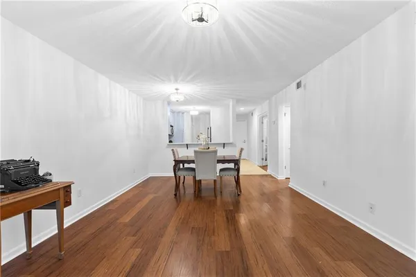 a view of a dining room with furniture and wooden floor