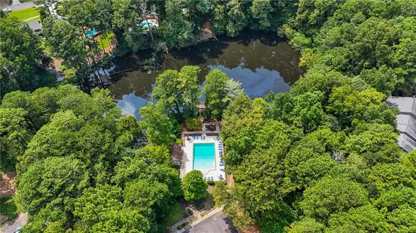 an aerial view of a house with a yard and a large pool