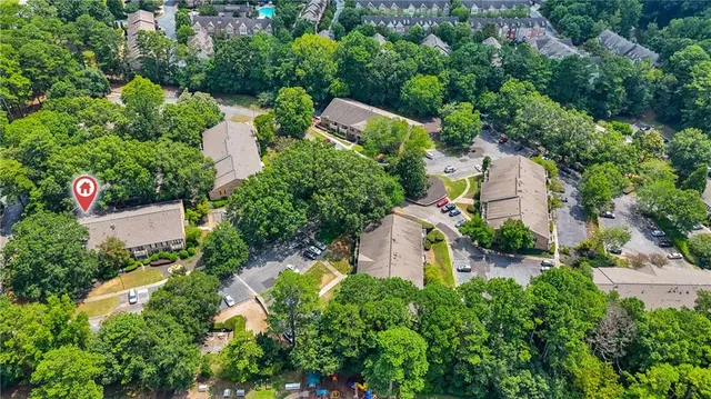 an aerial view of a house with a yard basket ball court and outdoor seating