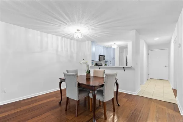 a view of a dining room with furniture wooden floor and chandelier