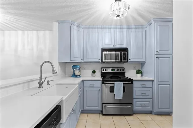 a kitchen with a sink stove and microwave