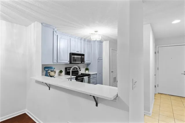 a view of a kitchen with microwave and cabinets
