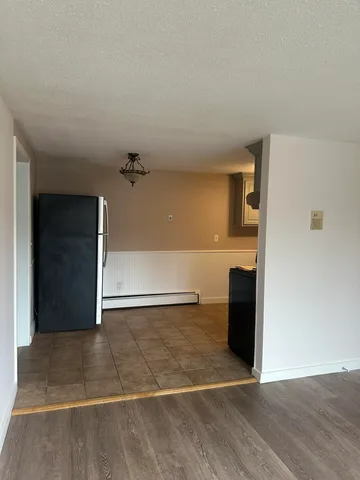 a view of a livingroom with a kitchen space and a window