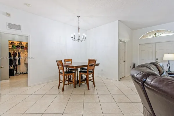 a dining room with furniture and chandelier