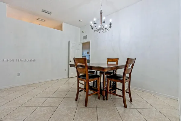 a view of a dining room with furniture and chandelier