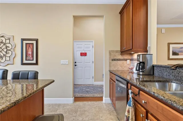 a kitchen with stainless steel appliances granite countertop a stove a sink dishwasher and cabinets with wooden floor