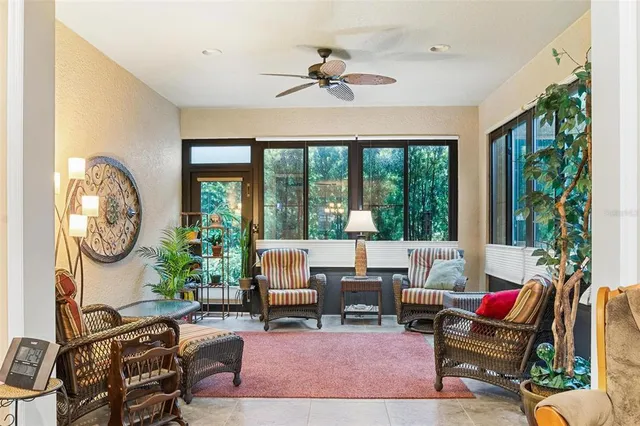 a living room with furniture and floor to ceiling windows