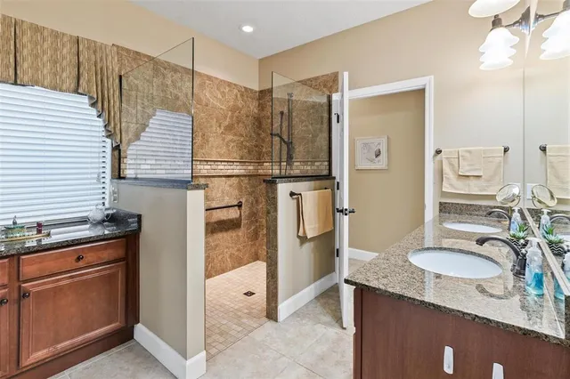 a bathroom with a granite countertop sink and a mirror