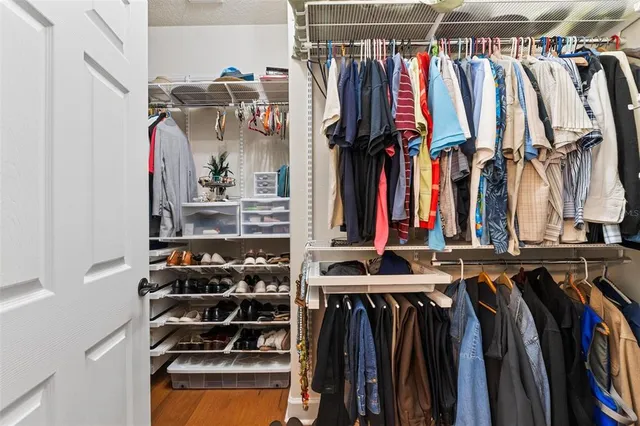 a white toilet sitting next to a white wall