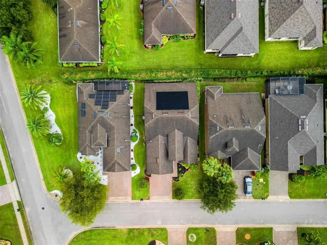 an aerial view of a house with a yard