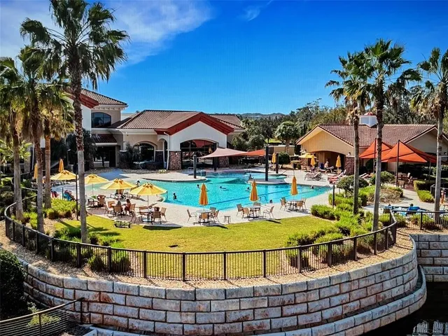 a room with pool table and windows
