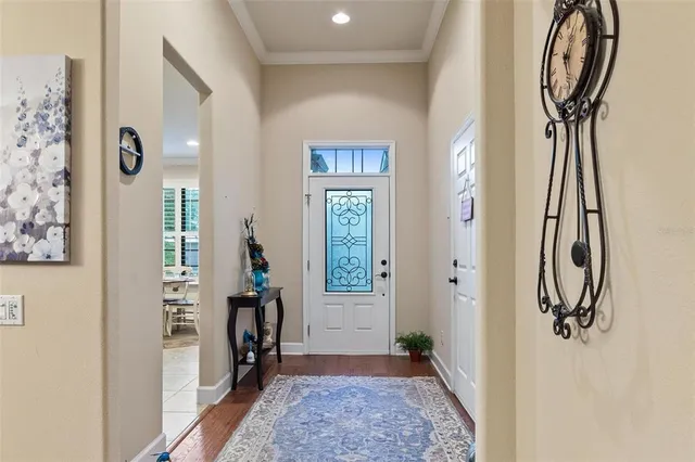 a kitchen with stainless steel appliances granite countertop a stove top oven a sink dishwasher a dining table and chairs with wooden floor