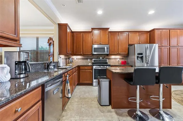 a view of a kitchen area with furniture and wooden floor