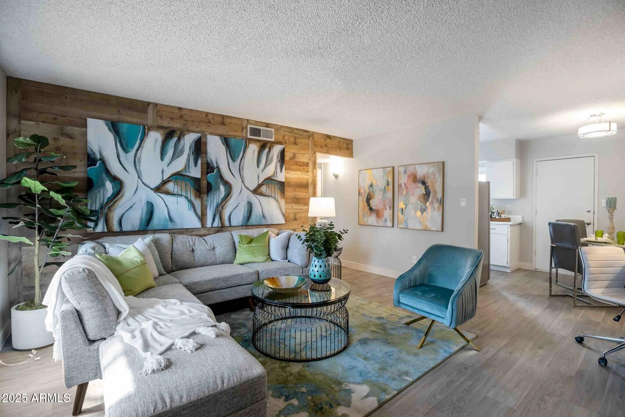 2627 North 45th Avenue, Unit 3C Phoenix, AZ 85035 - Photo 1 of 29 a living room with furniture and a rug