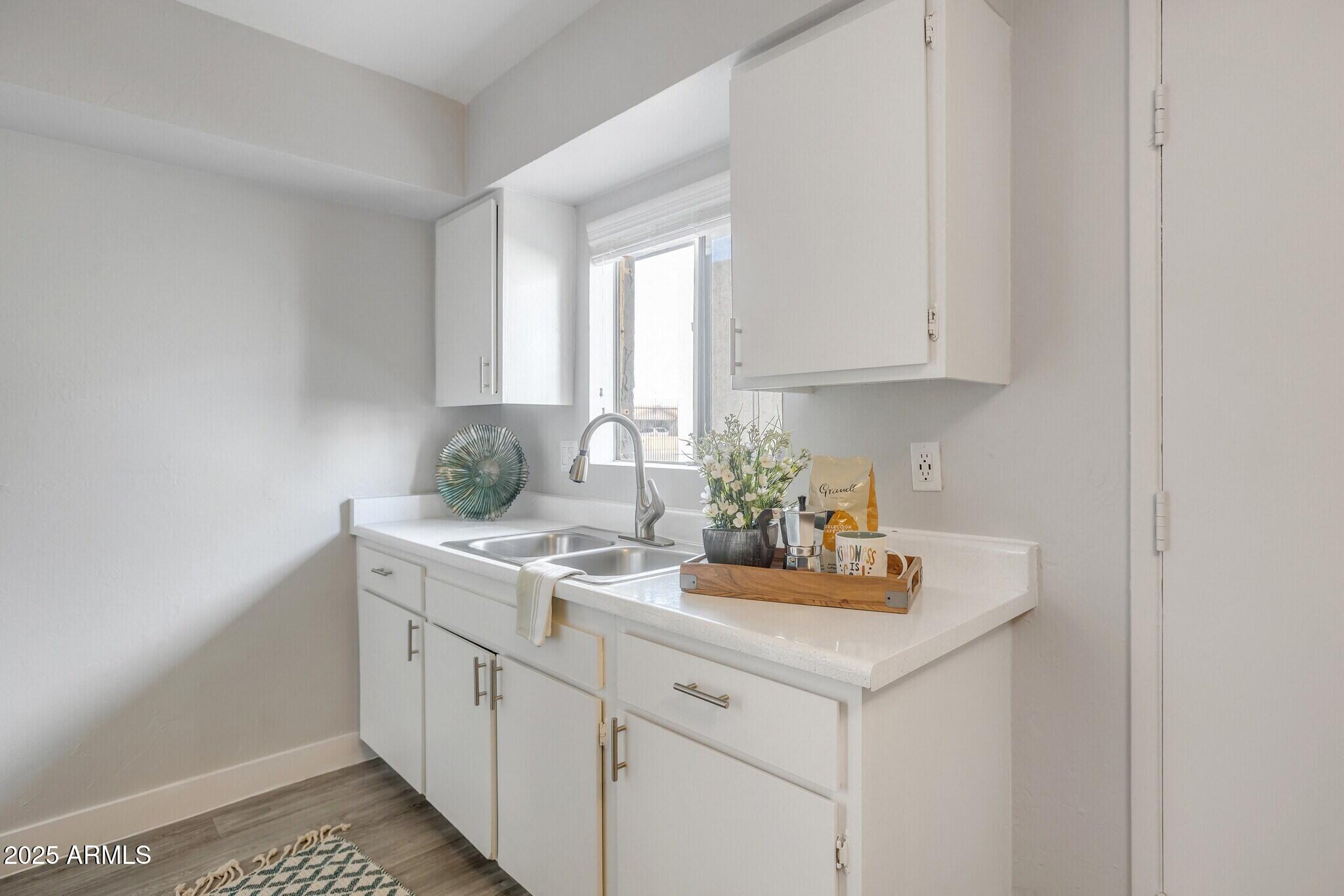 2627 North 45th Avenue, Unit 3C Phoenix, AZ 85035 - Photo 5 of 29 a kitchen with a sink cabinets and window